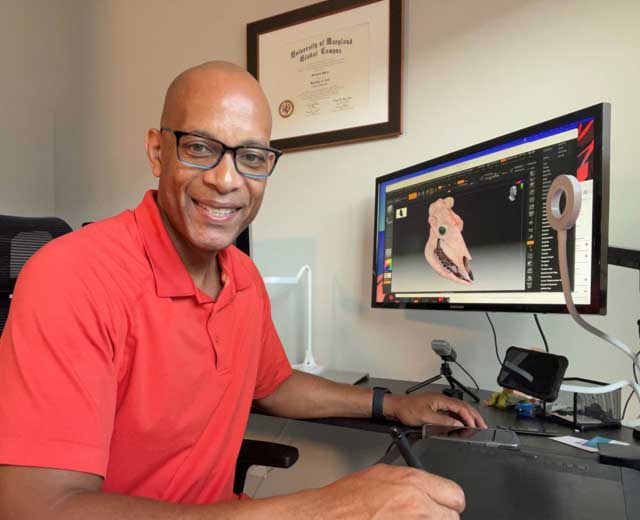 Micheall Myrie at his workstation